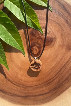 Evil Eye amulet necklace.  The evil eye is an ancient symbol used to guard the wearer against evil, negative energy, bad & nefarious intentions. Handmade with beautiful rosewood and wood burning technique called pyrography.  Sealed with natural food grade mineral oil.  Comes with approx. 20 inch black necklace cord. (Starter chain) Bohemian Natural Wood Necklaces As Gift, Bohemian Natural Wood Necklace As Gift, Symbolic Brown Pendant Necklace, Spiritual Natural Wood Necklaces As Gift, Spiritual Natural Wood Necklaces For Gifts, Natural Wood Spiritual Necklaces For Gifts, Spiritual Natural Wood Jewelry Gift, Evil Eye Amulet, Wood Burning Techniques