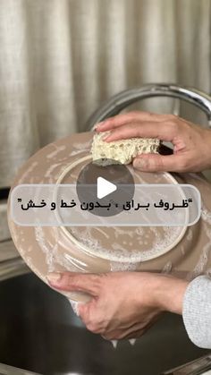 a person is holding a plate with food on it in front of a kitchen sink