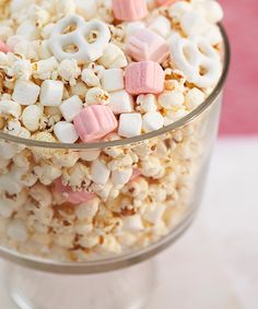 a glass bowl filled with marshmallows and pretzels