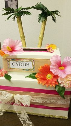 a cake decorated with flowers and palm trees