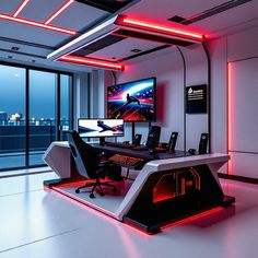 a computer desk with two monitors on top of it in front of a large window