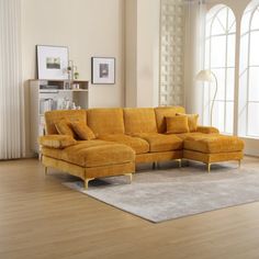 a living room with a yellow couch and rug