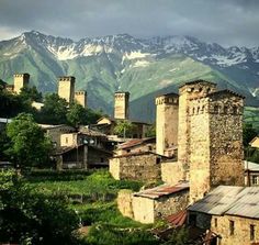 an old village with mountains in the background