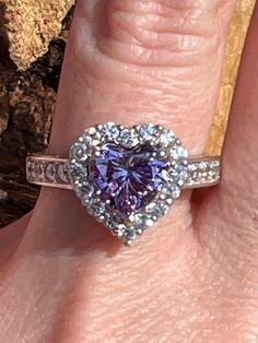 The purple cubic zirconia in this ring has a measurement of approx. 7.8mm x 7.5mm. The other cubic zirconias in this ring have a measurement of approx. 1.9mm. The back of shank has a measurement of approx. 3.4mm. This ring weighs approx. 4.7 grams. Size: 8 US. Stock number: 257 Purple Brilliant Cut Rings For Promise, Purple Amethyst Heart Cut Ring For Valentine's Day, Purple Brilliant Cut Diamond Ring Gift, Purple Heart Ring For Promise, Fine Jewelry, Gift Purple Brilliant Cut Diamond Ring, Lavender Brilliant Cut Rings For Gift, Elegant Purple Heart Ring For Anniversary, Purple Promise Rings For Valentine's Day, Valentine's Day Purple Diamond Jewelry