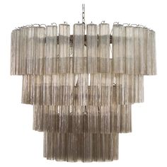 a large chandelier made out of glass tubes and metal rods on a white background