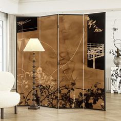 the room divider is decorated with black and white flowers, leaves and branches on it