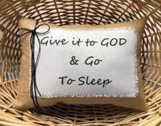 a pillow that says give it to god and go to sleep on top of a wicker basket