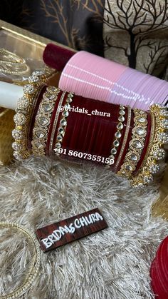 two red and pink bangles sitting next to each other on a white fur rug