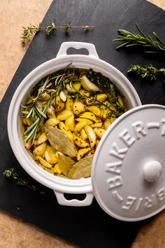 a casserole dish with potatoes and herbs