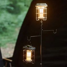 a light that is sitting on top of a pole next to a lamp holder with an object in it