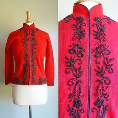 Ultra silky-soft, exotic 1950s cardigan features a structured mandarin collar; cherry-red angora; and heavy jet-black floral beading that vines around the wrists, hem, neck and front center. Fully lined in red nylon. Black piping finishes the edges. Wear it open, or fully closed, with a hidden front placket of hook-and-eye loops from neck to hem. Made in Hong Kong; excellent condition. Perfect to elevate everyday ensembles or for formal occasions. Just as striking with jeans or topping a dress. Embroidered Winter Evening Outerwear, Elegant Embroidered Winter Cardigan, Fitted Embroidered Vintage Outerwear, Fitted Winter Evening Cardigan, Fitted Evening Cardigan For Winter, Traditional Fitted Evening Outerwear, Winter Evening Fitted Cardigan, Fitted Wool Vintage Cardigan, Traditional Evening Outerwear For Winter