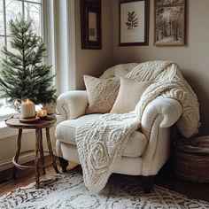 a living room with a christmas tree in the corner and a white chair next to it