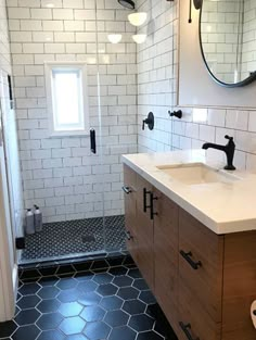 a bathroom with black and white tile flooring