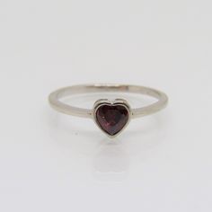 Sterling Silver Garnet Heart Ring....Marked 925...Total of weights 1.2grams... Size 7...Measure of Face 6MM...It's in very good condition. Sterling Silver Heart-shaped Ruby Ring In White Gold, Heart-shaped Ruby Ring In White Gold, Sterling Silver Heart-shaped Ruby Ring, Heart-shaped Sterling Silver Ruby Ring, Heart-shaped Sterling Silver Ruby Ring, Fine Jewelry, Heart Shaped Ruby Ring In Sterling Silver, Sterling Silver Heart-shaped Stackable Rings, Stackable Heart Cut Sterling Silver Ring, Garnet Ring Vintage