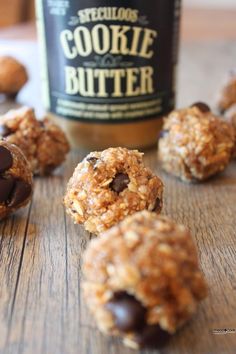 chocolate chip cookies and peanut butter balls on a wooden table with a jar of peanut butter in the background