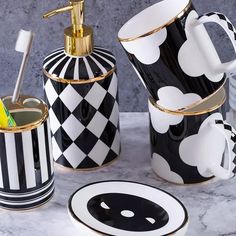 black and white bathroom accessories with gold accents