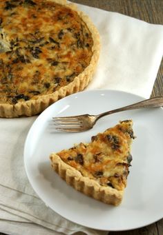 a slice of quiche on a plate with a fork