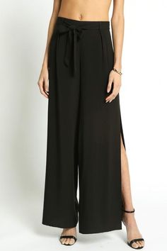 Show off your 'graceful lines' in these stunning wide leg pants this season. The black pants feature a sexy side slit to show off your lower legs and some open toed high heels. The fitted waist has a self tying belt. Available in black 100% rayon Imported Linen Pants Black, Hammer Pants, Best Pants, Black Capri Pants, White Linen Pants, Trousers For Women, Dresses And Shoes, Plaid Pants, Cropped Trousers