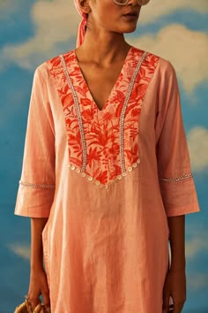 Editor's Note Featuring This Graceful Bright Coral Dove Kurt Set With Lurex As The Base Fabric. The Set Comprises Of Short Kurta With Straight Ankle Lengthpants With Additional Cut Dana Detailing On The Neckline And Hemline Of The Pants. Color: Coral Fabric: Lurex Care: Dry Clean Only About the Designer Rishi & Vibhuti label combines traditional elements with modern aesthetic uniquely to create chic occasion wear for women with a fine choice. The global appeal in their designs has made Rishi & V Neckline For Kurtis, Short Tunics For Women, Modern Kurta Designs Women, Short Kurti Neck Designs, Unique Kurta Designs Women, Short Kurta With Pants, Rishi Vibhuti, Straight Kurti Designs, Suit Stitching