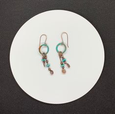 Beautiful turquoise blue Patinated Copper with hammered copper and dyed Howlite Dangles. On handmade Copper Ear wires. I think these earring would look great with this necklace: https://monkeyliondesigns.com/collections/necklace/products/patinated-copper-and-howlite-necklace An original Monkeylion Design.Approximately 2 5/16" long and 5/8" wideThese earrings have been antiqued, polished and sealed.Sealed with Protectaclear ProtectaClear is a clear, protective coating that is tough enough to prot Blue Artisan Copper Earrings, Artisan Blue Copper Earrings, Artisan Turquoise Copper Earrings, Artisan Turquoise Earrings In Copper, Rustic Turquoise Nickel-free Earrings, Rustic Turquoise Nickel Free Earrings, Blue Hand Forged Bohemian Earrings, Blue Bohemian Hand Forged Earrings, Turquoise Artisan Electroformed Earrings