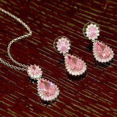 Lavencious is proud to present its exquisite Teardrop Dangle with AAA Pink Cubic Zirconia Necklace & Earrings Set. This hand-crafted set is made with brilliance and care, featuring high-grade AAA pink cubic zirconia stones, making it a luxurious addition to any jewelry collection. The necklace and earrings feature a classic teardrop silhouette, ensuring timeless elegance. - Necklace is 16" x 3" length,pendant and earrings are the same size : 1.18" x 1.18" - Rhodium Plated to enhance shine and du Zirconia Necklace, Cubic Zirconia Necklace, Luxury Gift Box, Necklace And Earrings, Necklace Earring Set, 925 Sterling Silver Jewelry, Necklace Earrings, Druzy Ring, Earrings Set