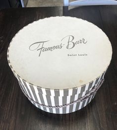 a round box sitting on top of a wooden table