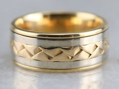 The workmanship of this Gelin Abaci band is incredible. Decorative braid work wraps around the center, and the colors are clean and sharp. While the base of the band is yellow gold, with two white gold stripes, and the center is yellow gold braided with delicacy and precision. Handsome and bold, this is an easy to wear band! Metal: 18K White and Yellow Gold Width of Band: 7.1 mm Height off Finger: 1.8 mm Ring Size: 3.75 SKU #: JA0QJ0UD Each piece has been identified and graded by a Graduate Gemo Right Hand Ring, Cameo Ring, Right Hand Rings, Hand Ring, White Gold Band, Gold Stripes, Gold Band, Hand Engraving, New Hampshire