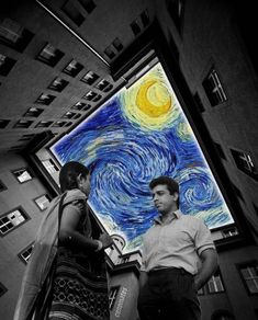 two people are standing in front of a painting that looks like a starry night