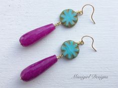 These beautiful statement earrings were created with 15mm Czech glass turquoise beads and 30x8mm purple jade teardrop beads. These stunning earrings dangle from gold plated ear wires and measure 2 1/2 inches in length. These stylish and chic earrings would be the perfect gift for you or someone special. All earrings will arrive to you in a gift box tied with a bow for easy gift giving and a small zipper baggie for storage. Earrings will also arrive with clear rubber backs to protect them from lo Bohemian Gemstone Teardrop Earrings For Gift, Bohemian Drop Gemstone Earrings, Bohemian Gemstone Teardrop Earrings, Purple Teardrop Earrings With Dangling Beads, Handmade Pink Bohemian Teardrop Earrings, Pink Bohemian Teardrop Earrings, Bohemian Pink Teardrop Earrings, Bohemian Pink Teardrop Dangle Earrings, Purple Teardrop Bohemian Earrings