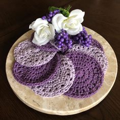 there is a crocheted cake with flowers on the top and purple icing