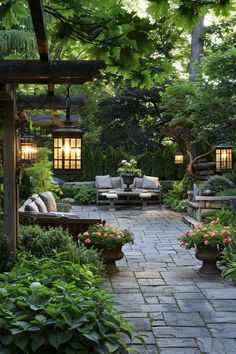 an outdoor patio with seating and potted plants in the center, surrounded by greenery