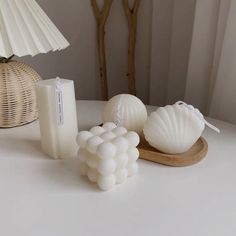 a white table topped with candles and seashells