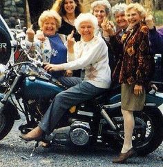 a group of older women standing next to each other near a parked motorcycle with the caption, ain't no party like nana's tea party