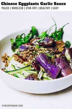 a white bowl filled with vegetables on top of a table