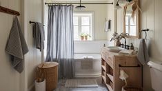 a bathroom with a sink, toilet and bathtub next to a window in it