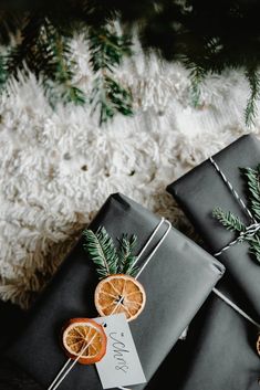 presents wrapped in black paper and decorated with orange slices