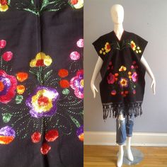 Gorgeous Ethnic Guatemalan Fringe Poncho Hand Made /  Hand Embroidered Rich Colourful Floral Motif With Fringe Detail Completely Open On Sides Excellent Vintage Condition One Size Fits Most Please Refer to Measurements to Ensure Best Fit With Poncho  Lying Flat, in inches: Width:  27 Total Length: 38 Multicolor Floral Embroidered Shawl For Festival, Bohemian Floral Embroidered Shawl For Festival, Bohemian Shawl With Floral Embroidery For Festival, Multicolor Floral Embroidered Festival Shawl, Spring Festival Embroidered Poncho, Bohemian Embroidered Shawl Fabric, Bohemian Multicolor Floral Embroidered Poncho, Festival Poncho With Multicolor Floral Embroidery, Traditional Poncho With Floral Embroidery