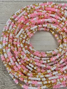 pink and white beaded bracelets with gold accents