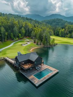 an aerial view of a house on a dock in the middle of a body of water