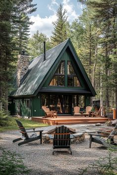 a small cabin in the woods with two chairs and a fire pit on gravel ground