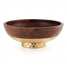 a wooden bowl with gold dots on it