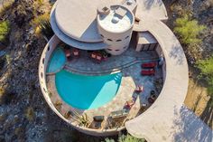 an aerial view of a house with a pool and hot tub in the middle of it