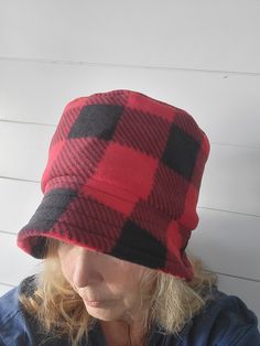 Warm and soft. This fleece bucket hat will keep your head warm even in the coldest winter. Woman's  bucket hat. Fleece fabric. Machine washable. These hats fits 21"-24"maximum head circumference at eyebrow level with stretch ability. Hat is a beautiful black and red buffalo check print  with inside lining is a solid black fleece. Please measure  head before ordering. Due to health and hygiene reasons I do not accept returns on hats. MaddHatR is not affiliated with any organizations, manufacturer Reversible Brimmed Bucket Hat For Winter, Reversible Short Brim Winter Hat, Winter Reversible Hat With Short Brim, Winter Outdoor Sun Hat, Reversible Winter Hats For Outdoor, Winter Reversible Hats For Outdoor, Adjustable Bucket Hat For Cold Weather, Winter Outdoor Reversible Hats, Fleece Bucket Hat