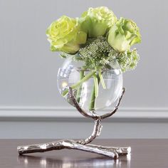 a vase filled with flowers sitting on top of a table