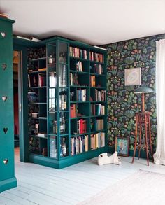 a living room with bookshelves filled with lots of books