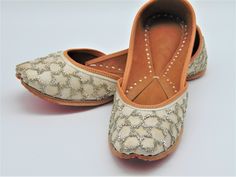 Ethnic Indian/Pakistani style shoes durable and hand stitched with genuine leather sole and leather padded cushion inside. These lovely shoes with white and sliver bead design is absolutely perfect for our brides to be, these offer cushion and comfort when wearing them around. The perfect shoe to pair with every outfit. We offer many different designs of shoes to choose from. See our page for more of our collection! We ship out in a timely matter, wrapped in care for a safe secure trip to your l Embroidered Leather Flats With Flat Heel, Leather Embroidered Flats, Embroidered Leather Slip-on Flats, Leather Wedding Flats With Leather Sole, Leather Flats With Leather Sole For Wedding, Leather Flats For Wedding, Festive Handwork Leather Flats, Festive Leather Flats With Handwork, Festive Embroidered Leather Flats