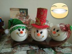 three snowmen are sitting on a table