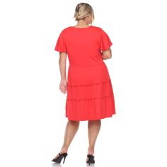 Our flouncy tiered design gives this midi dress a simple but elegant look. The easy, breezy style is what makes if a perfect casual wear on hot days. The loose fit will compliment and flatter all body types. It features a V-neckline, a faux button down front and flutter sleeves. -Care Instructions: Machine Wash Cold -Material: 96% Polyester, 4% Spandex Product Specifications: -V-Neck -Tiered -Short Dress Casual Tiered Dress With Ruffle Hem, Casual Layered Hem Tiered Dress, Casual Tiered Dress With Layered Hem, Flowy Tiered Casual Midi Dress, Flowy Tiered Midi Dress Casual Style, Flowy Tiered Midi Dress Casual, Casual Flowy Midi Dress With Tiered Skirt, Solid Color Tiered Midi Dress For Summer, Solid Color Tiered Summer Dress