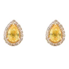 These delicate yellow sapphire gemstone earrings are an exquisite addition to any jewelry collection. Crafted with care, each earring features a stunning 6.5 x 4.5 MM pear-cut halo diamond stud, adding a touch of elegance and sophistication. Handmade with love, these earrings make a perfect Valentine's Day gift for your loved one. The fine jewelry set is designed to catch the light and dazzle on any occasion. Enhance your style with these remarkable earrings that embody timeless beauty and grace.  PRODUCT DETAILS :-  > Material - 18K Solid Yellow Gold > Gemstone - Yellow sapphire > Gemstone Weight - 0.87 ct > Gemstone pcs - 2 > Gemstone size - 6.5 x 4.5 mm > Gemstone shape - Pear > Diamond Weight - 0.24 ct > Gross Weight - 1.393 Grm > Setting - Prong, Halo setting > Lock Mechanism - Push B Pear Earrings, Rose Gold Earrings Studs, Rose Gold Studs, Opal Earrings Stud, Halo Setting, Opal Studs, Diamond Stud Earrings, Pear Diamond, Diamond Stud