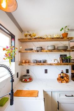 the kitchen is clean and ready to be used for cooking or baking, as well as other things that are on the shelves